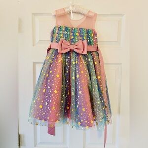 Gorgeous dress with tulle and stars and a big bow girls size 6/7 has a stain